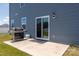Patio view featuring a grill, smooth concrete, and the back exterior of a two-story blue home at 9529 Cotswood Pl, Gastonia, NC 28056