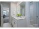 Bright bathroom with a double sink vanity and a view into the bedroom and shower stall at 9529 Cotswood Pl, Gastonia, NC 28056