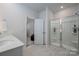 Bathroom features double sinks, walk in shower, and a tile floor at 9529 Cotswood Pl, Gastonia, NC 28056