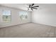 Bright bedroom with neutral carpet, a ceiling fan, and bright windows, offering ample natural light at 9529 Cotswood Pl, Gastonia, NC 28056
