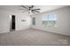 Bedroom featuring neutral carpet, a ceiling fan, bright window and a walk-in closet at 9529 Cotswood Pl, Gastonia, NC 28056