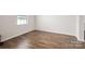 Bright bedroom with hardwood floors and a large window providing natural light at 9529 Cotswood Pl, Gastonia, NC 28056
