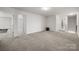 Spacious bedroom with neutral carpet, white walls, and multiple entryways with a large walk in closet at 9529 Cotswood Pl, Gastonia, NC 28056