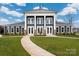 Beautiful community clubhouse with a symmetrical facade, offering a welcoming and elegant gathering space at 9529 Cotswood Pl, Gastonia, NC 28056