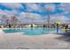 Large community pool with lounge chairs and a splash pad, perfect for summer relaxation and recreation at 9529 Cotswood Pl, Gastonia, NC 28056
