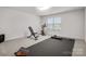 A bright exercise room features gym equipment, a large window and a black exercise mat at 9529 Cotswood Pl, Gastonia, NC 28056