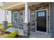 Welcoming front entrance with a black front door, gray stone facade, and Craftsman style columns at 9529 Cotswood Pl, Gastonia, NC 28056