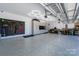 Spacious garage with gray epoxy floors, slat wall, custom cabinetry, and unique lighting at 9529 Cotswood Pl, Gastonia, NC 28056