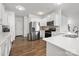 Modern kitchen with stainless steel appliances, white cabinets, and hardwood floors at 9529 Cotswood Pl, Gastonia, NC 28056