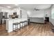 Open concept with a kitchen island, white cabinets and living room with a fireplace at 9529 Cotswood Pl, Gastonia, NC 28056