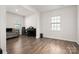 Spacious living room with hardwood floors, a cozy couch, and a piano at 9529 Cotswood Pl, Gastonia, NC 28056