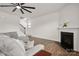 Comfortable living room with a fireplace, a ceiling fan, and stairs to the second floor at 9529 Cotswood Pl, Gastonia, NC 28056