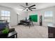 Well-lit home office setup with a modern desk, a comfortable sofa, and a large ceiling fan at 9529 Cotswood Pl, Gastonia, NC 28056