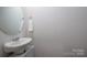 Powder room features a mirror, sink, modern faucet, and neutral colors at 9529 Cotswood Pl, Gastonia, NC 28056