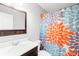 Bright bathroom features a wood vanity and colorful shower curtain at 103 Chambwood Ln, Shelby, NC 28152