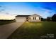 Charming single-story home at dusk with attached two car garage at 103 Chambwood Ln, Shelby, NC 28152