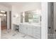 Bathroom featuring gray cabinets, marble tile floor, a large mirror, and a walk-in shower at 11008 Strike The Gold Ln, Waxhaw, NC 28173