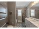 Bathroom showcasing a floral patterned floor, double door entry, and gray vanity at 11008 Strike The Gold Ln, Waxhaw, NC 28173