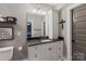 Clean bathroom featuring a granite countertop vanity, decorative mirror, and neutral wall color at 11008 Strike The Gold Ln, Waxhaw, NC 28173