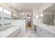 The elegant bathroom has a soaking tub, glass shower, marble floors and double vanity sinks at 11008 Strike The Gold Ln, Waxhaw, NC 28173
