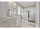 Modern bathroom with a white vanity, a glass enclosed shower and sleek fixtures at 11008 Strike The Gold Ln, Waxhaw, NC 28173
