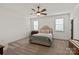 Bright bedroom with a cozy bed, soft carpet, and natural light from two windows at 11008 Strike The Gold Ln, Waxhaw, NC 28173