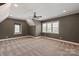 An empty carpeted room with two windows with blinds and a ceiling fan at 11008 Strike The Gold Ln, Waxhaw, NC 28173