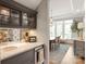 Butler's pantry with marble countertop, glass-front cabinets, and view into dining room at 11008 Strike The Gold Ln, Waxhaw, NC 28173