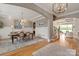 Spacious dining room with hardwood floors, a chandelier, and an elegant arched entryway at 11008 Strike The Gold Ln, Waxhaw, NC 28173