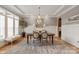 Elegant dining room featuring a chandelier, wainscoting, and large windows for natural light at 11008 Strike The Gold Ln, Waxhaw, NC 28173