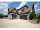 A three-car garage with a large concrete driveway and brick exterior adds to the curb appeal at 11008 Strike The Gold Ln, Waxhaw, NC 28173
