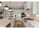 Modern kitchen showcasing stainless steel appliances, white cabinets, and a marble countertop island at 11008 Strike The Gold Ln, Waxhaw, NC 28173