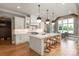 Spacious kitchen with white cabinets, marble countertops, stainless appliances and a large center island at 11008 Strike The Gold Ln, Waxhaw, NC 28173