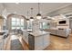 Open-concept kitchen flowing into the living space, features a large island and modern appliances at 11008 Strike The Gold Ln, Waxhaw, NC 28173
