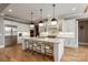Gourmet kitchen featuring a large island, stainless steel appliances, and pendant lighting at 11008 Strike The Gold Ln, Waxhaw, NC 28173