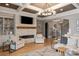 Comfortable living room with a stone fireplace, built-in shelving, and coffered ceiling at 11008 Strike The Gold Ln, Waxhaw, NC 28173