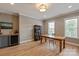 Bright living area with hardwood floors, a wine cooler, and custom shelving creates an inviting space at 11008 Strike The Gold Ln, Waxhaw, NC 28173