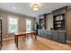 Spacious living room featuring hardwood floors, custom cabinets, and natural light from bright windows at 11008 Strike The Gold Ln, Waxhaw, NC 28173