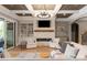 Bright living room featuring a stone fireplace, custom built-ins, and a coffered ceiling at 11008 Strike The Gold Ln, Waxhaw, NC 28173