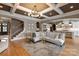 Spacious living room with coffered ceilings, hardwood floors, and open layout to kitchen and stairs at 11008 Strike The Gold Ln, Waxhaw, NC 28173