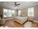 Spacious main bedroom features a tray ceiling, hardwood floors, and multiple windows for natural light at 11008 Strike The Gold Ln, Waxhaw, NC 28173