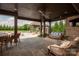 Inviting outdoor patio with a lounge area, outdoor fireplace, and views of the lush backyard at 11008 Strike The Gold Ln, Waxhaw, NC 28173