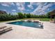 Backyard pool with sun loungers and a jacuzzi offers a resort-like experience in a private setting at 11008 Strike The Gold Ln, Waxhaw, NC 28173