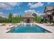 Luxurious pool with integrated spa, pool house with bar and fireplace, and lounge area at 11008 Strike The Gold Ln, Waxhaw, NC 28173