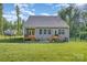 Well-manicured backyard with a wooden deck, fenced perimeter, and a large grassy area perfect for outdoor activities at 11226 Dappled Light Trl, Charlotte, NC 28227