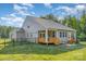 Spacious backyard features a covered wooden deck, fenced yard, and mature landscaping at 11226 Dappled Light Trl, Charlotte, NC 28227