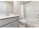 Clean bathroom with vanity, white tile tub and shower, and sleek gray flooring at 11226 Dappled Light Trl, Charlotte, NC 28227