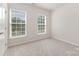 Simple bedroom featuring carpet flooring, neutral walls, and natural light from the two windows at 11226 Dappled Light Trl, Charlotte, NC 28227