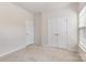 Bright, carpeted bedroom featuring neutral walls and two large closets for ample storage space at 11226 Dappled Light Trl, Charlotte, NC 28227