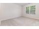 Bright bedroom with carpet, a large window offering a view of the outdoors, and neutral walls at 11226 Dappled Light Trl, Charlotte, NC 28227